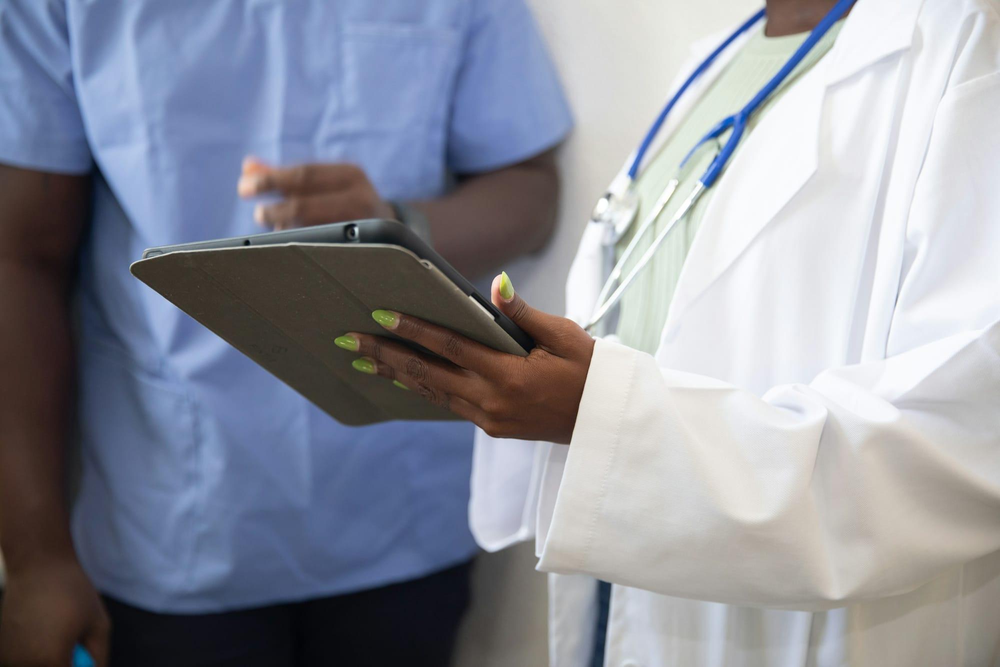 Doctor showing a patient something on a tablet