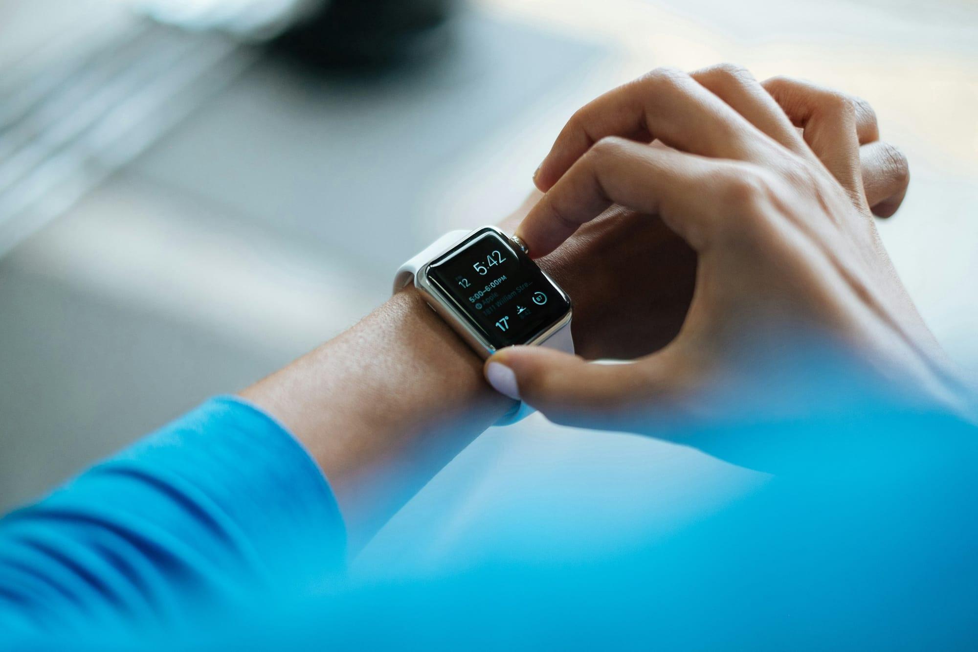 Person checking a smartwatch on their wrist